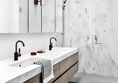 Luxury bathroom design preview with a white marble-look vanity and seamless stone walls in our virtual bathroom designer.