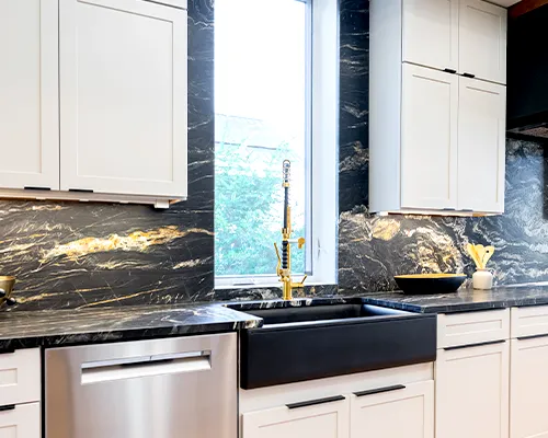 High-end kitchen with a full-height stone backsplash matching the custom countertops for a seamless look.