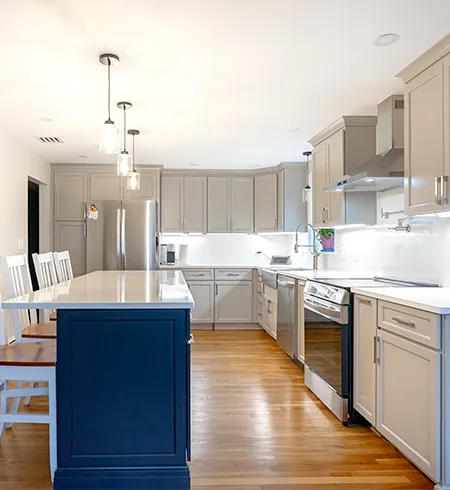Custom quartz kitchen countertops with a matching full-height backsplash in Braintree, MA.