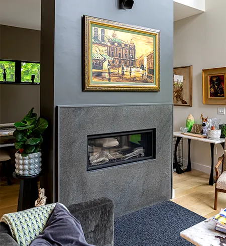 Luxury quartzite kitchen countertops and dramatic stone fireplace wall installed in Marblehead, MA.